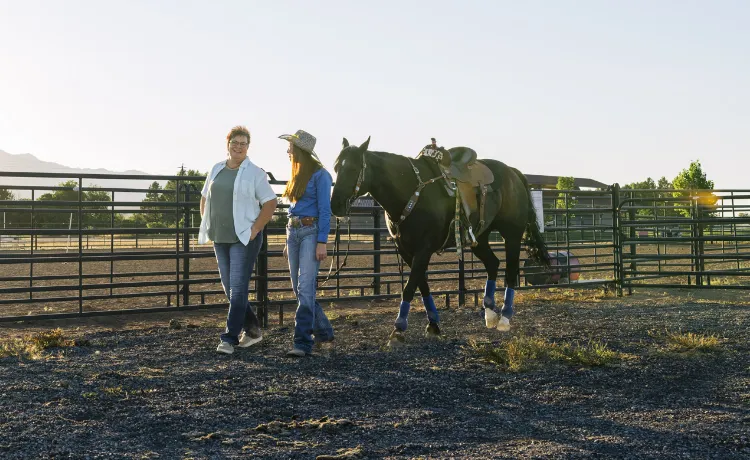 Vanessa, a real GLASSIA patient, with her friend, who is leading a horse by the reins.